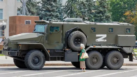 Reuters An armoured truck of pro-Russian troops is parked near Ukraine's former regional council's building in Kherson