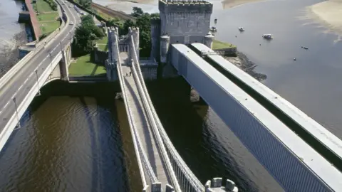 Getty Images Aerial photo showing three bridges across the muddy coloured River Conwy - the road bridge is the one on the left