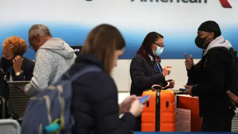 Getty Images Passengers wait for flights to resume on Wednesday morning at Ronald Reagan Washington National Airport