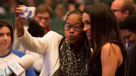 One Young World Delegate at One Young World summit in 2014 takes a selfie with Meghan Markle