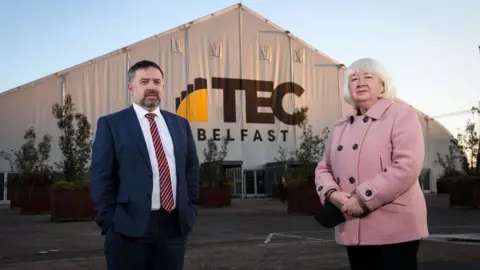 Department of Health Health Minister Robin Swann and Patricia Donnelly, head of NI's vaccine programme, outside the TEC