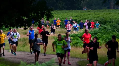 PA Media Runners take on the course at Bushy Park in south-west London - where Parkrun began in 2004