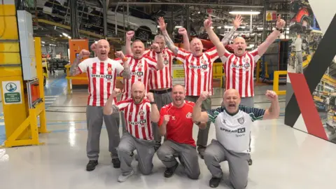Nissan workers cheering in Sunderland football strips