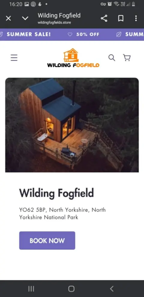 Amy Bennett A screenshot showing a lowlit cabin in the forest from a birdseye view. Underneath it says 'Wildling Fogfield' with a big button saying 'book now'. 