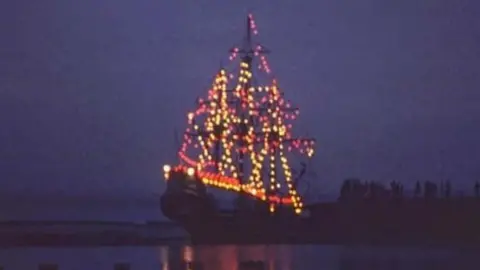 Lancashire County Council The slide shows an illuminated galleon on the water against a dark night sky