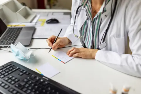 A doctor making notes, stock image