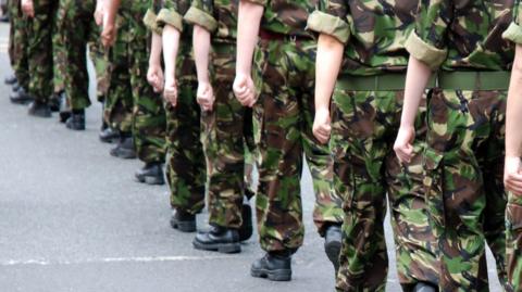 A row of people dressed in military uniform
