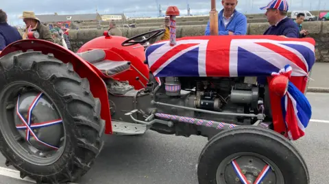 Image shows a small tractor draped in a Union Flag