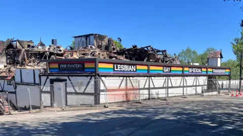 Rubble remains on the second floor of Pink Punters club which is surrounded by a steel fence.