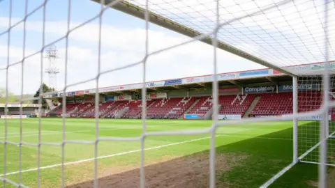 Getty A view through the football net of Cheltenham Town FC's stadium, looking towards the red seats