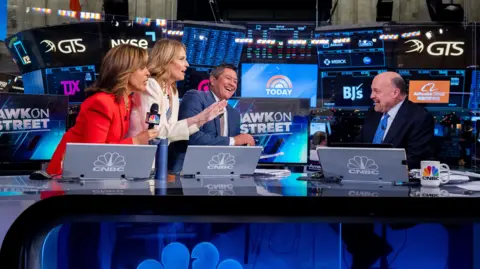 Getty Images Hoda Kotb, Savannah Guthrie, Jim Cramer and Carl Quintanilla at New York Stock Exchange studio of CNBC's Squawk on the Street show.
