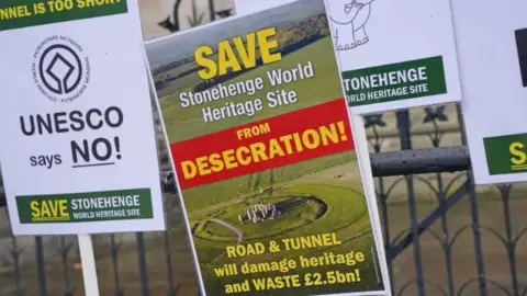 PA Media Posters asking people to save Stonehenge World Heritage site 