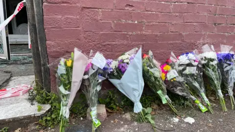 PA Media Flowers left outside house