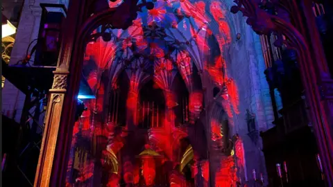 A light show on the walls and ceiling of the abbey