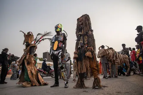 NICOLAS REMENE / AFP People wear elaborate costumes, some are chrome and futuristic in appearance, Others feature lots of hanging layers and attenae.