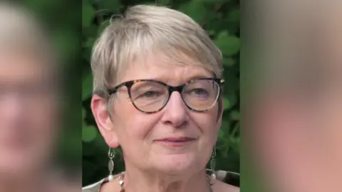 Sue Yeandle OBE A woman with glasses and short grey hair.