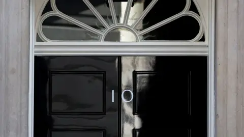 Close shot of the black No 10 Downing Street door