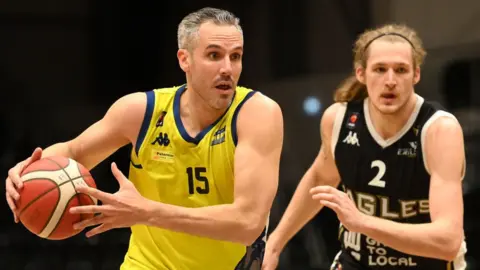 Getty/Stu Forster Mike Tuck in foreground playing basketball