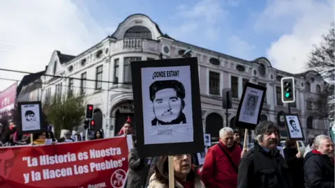 Getty Images Relatives of disappeared and executed political prisoners commemorate the 45th anniversary of the coup against Salvador Allende in Osorno, Chile. 11 September 2018