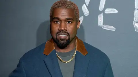 Getty Images Kanye West at a Versace event