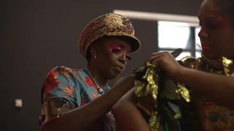 Anna de Escobar Symone working on a costume