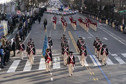 EPA Members of the military march on 15th Street towards the White House during a Presidential Escort of US President Joe Biden's limousine to the White House, in Washington, DC, USA, 20 January 2021.