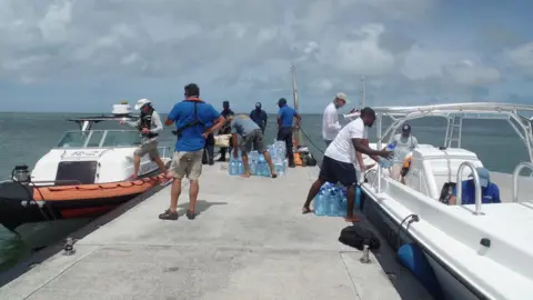 Gemma Handy Unloading emergency supplies at Barbuda dock