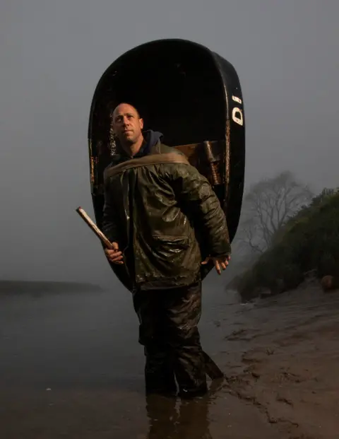 Joann Randles Fisherman Alex Hughes is pictured on the River Towy, Carmarthen, of the Carmarthen Coracle and Netsmen’s Association complete their fishing session of the morning.