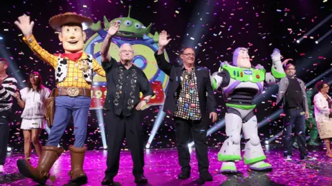 Getty Images (L-R) Composer Randy Newman of Toy Story 1,2 and 3 and director John Lasseter of Toy Story 4
