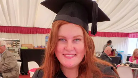 Family photo Tallie in her graduation cap