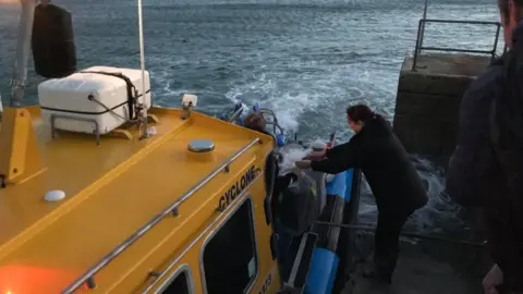 Bryher Campsite Ballot box being loaded on to jet boat