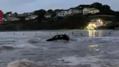 Car in water at Polzeath