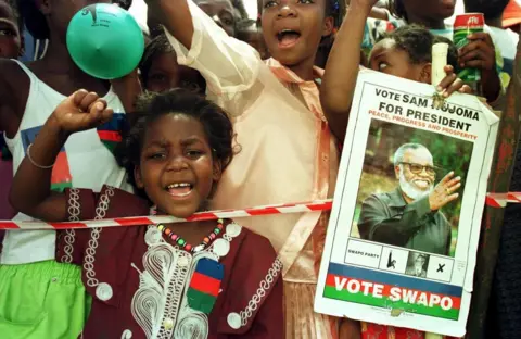 AFP Young Swapo supporters sing at the party's final election rally which was adressed by Sam Nujoma, Namibian president and SWAPO leader in Windhoek 28 November 1999. 