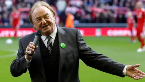 Reuters Gerry Marsden sings You'll Never Walk Alone before a Liverpool match against Blackburn Rovers at Anfield in 2010