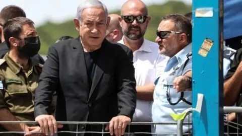 Reuters Benjamin Netanyahu visits the scene in Mount Meron. He called the deaths a "heavy disaster"