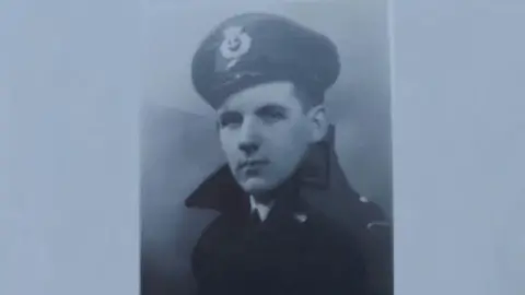 Supplied A black and white portrait photo of Russ Proudfoot looking serious in a uniform and cap