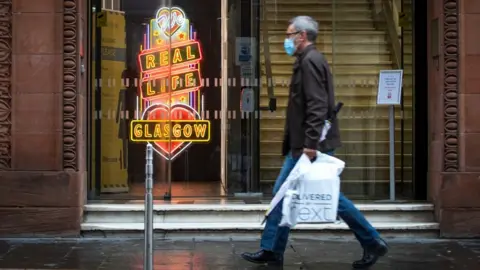 PA Media Man walking in Glasgow