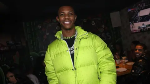 Getty Images A Boogie Wit Da Hoodie wearing a fluorescent jacket during his birthday celebration in 2023