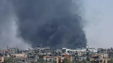 Reuters Smoke rises during an Israeli airstrike in Rafah, 24 May, 2024