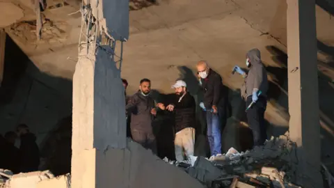 AFP Lebanese emergency responders gather at the site of a strike, reported by Lebanese media to be an Israeli strike targeting a Hamas office, in the southern suburb of Beirut on January 2, 2024.