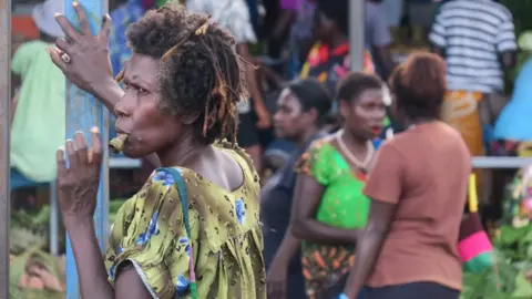 AFP Woman chewing betel nut on a market in Bougainville