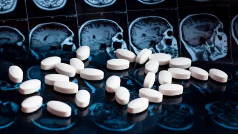 Getty Images Drugs in front of brain scans