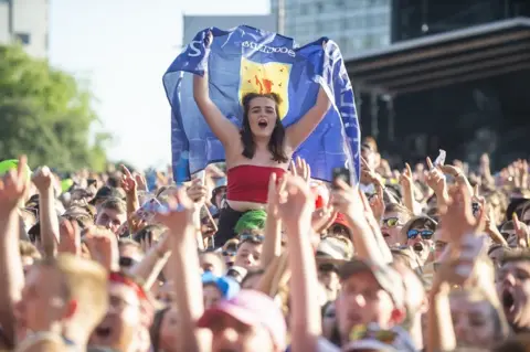 PA Media Fans watch Lewis Capaldi perform on the main stage during the TRNSMT festival in Glasgow