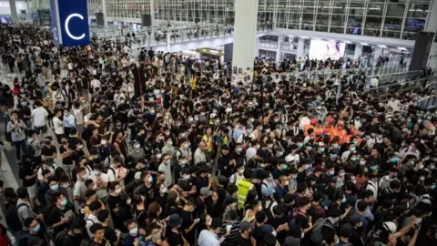 EPA Anti-government protestors at Hong Kong's airport