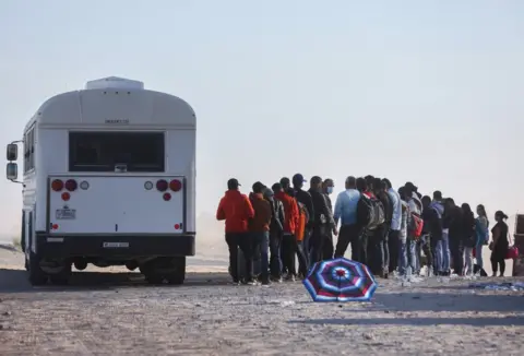 Getty Images A US border patrol bus takes migrants to a processing centre