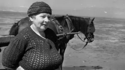 The National Library of Wales Women collecting cockles in Penclawdd on the Gower Peninsula in 1951