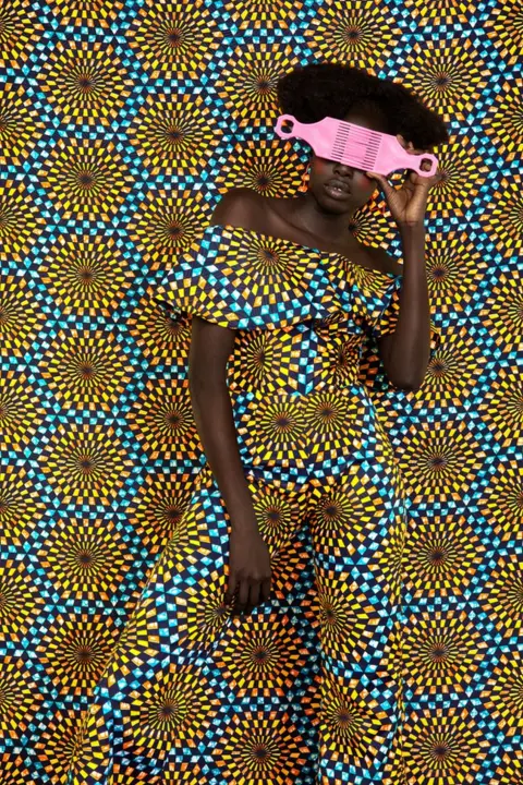 Thandiwe Muriu Woman disguised by sunflower fabric