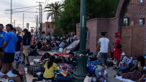 Reuters Migrants are camped out at a church in El Paso ahead of Title 42 ending