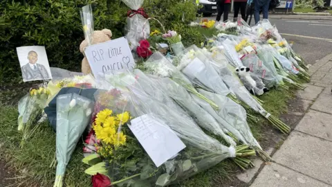 PA Media Flowers with one note which says 'RIP little angel'