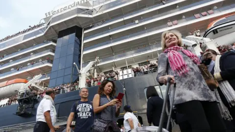 EPA Passengers leaving the Westerdam